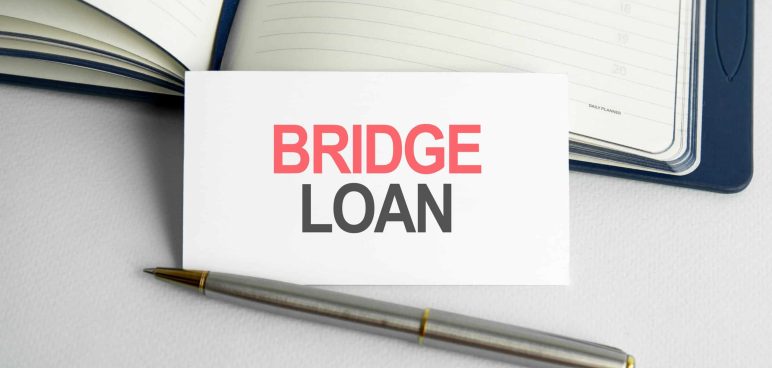 business-concept-text-bridge-loan-life-writing-paper-card-notebook-wooden-background-scaled – Tradition Credit How to Calculate a Bridging Loan in Singapore