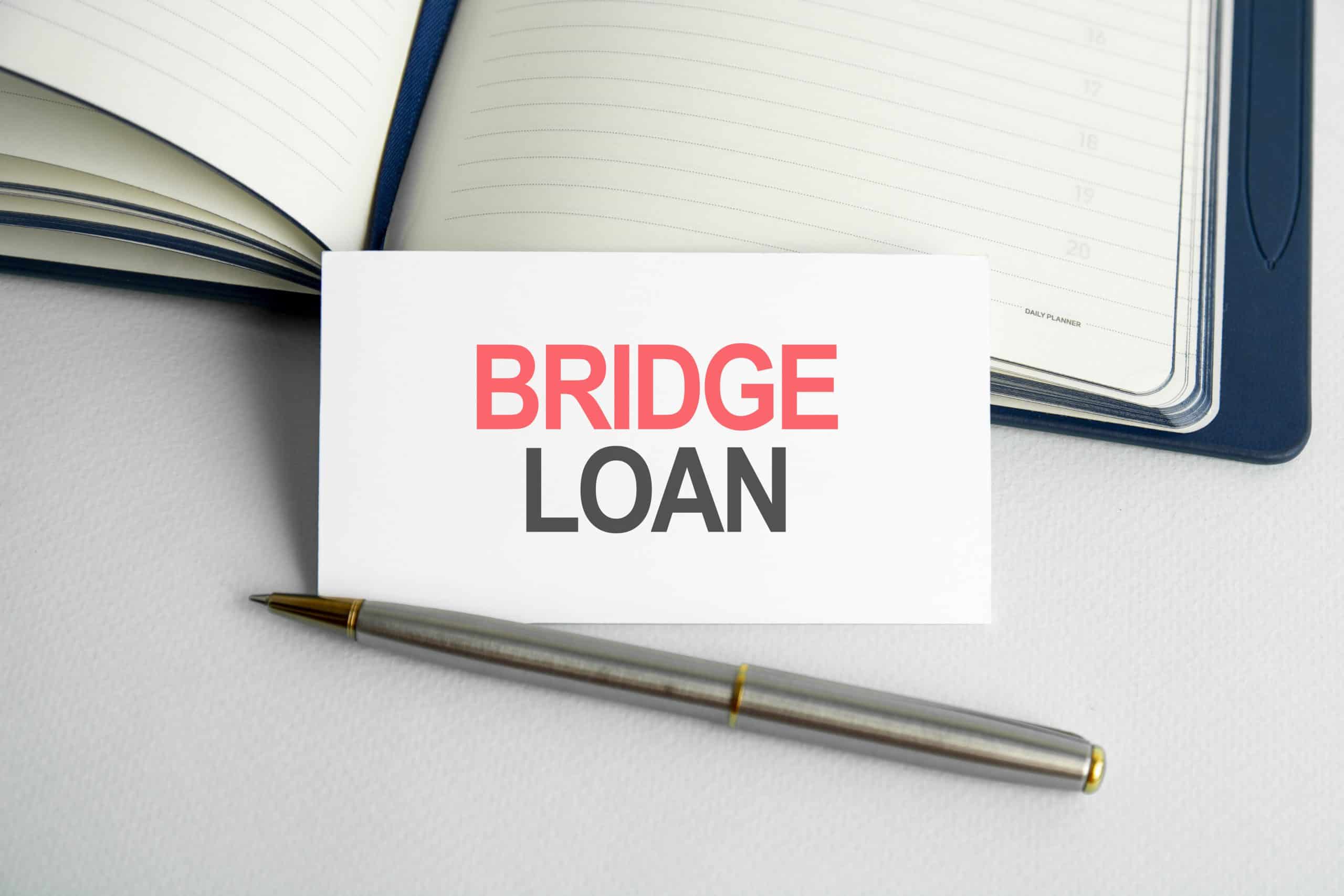 business-concept-text-bridge-loan-life-writing-paper-card-notebook-wooden-background-scaled – Tradition Credit How to Calculate a Bridging Loan in Singapore