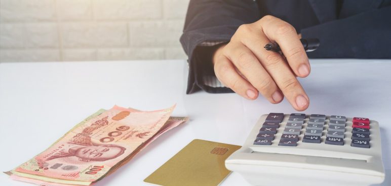 business woman computing money on desk