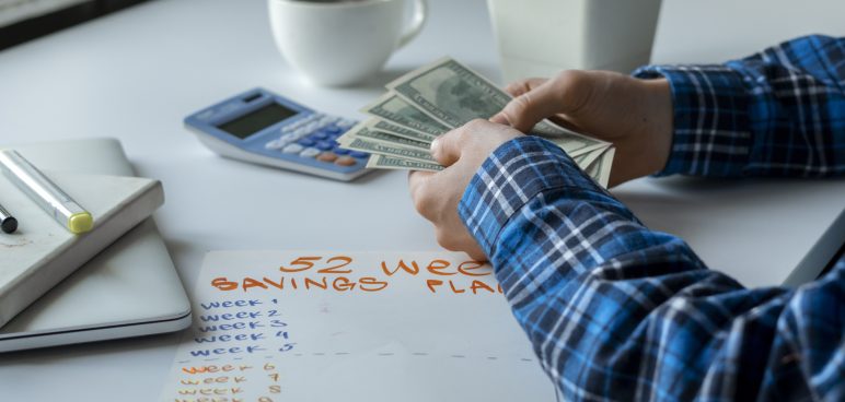man counting money and planning weekly budget