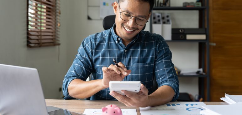 Businessman working with financial data hand using calculator and piggy saving Business financial and accounting concept – Tradition Credit Monthly Installment Loan Budgeting Blueprint